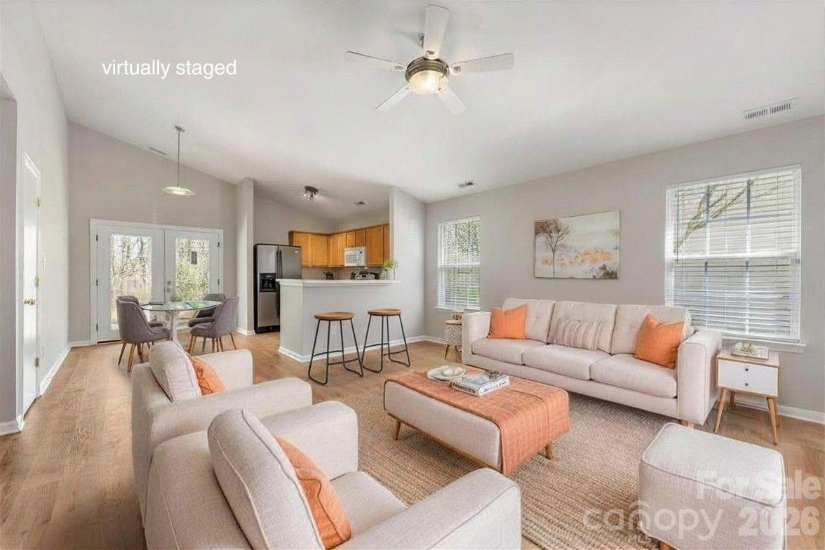 2872 Signal Court Southwest Concord, NC 28025 - Photo 2 of 43 a living room with furniture ceiling fan and a wooden floor