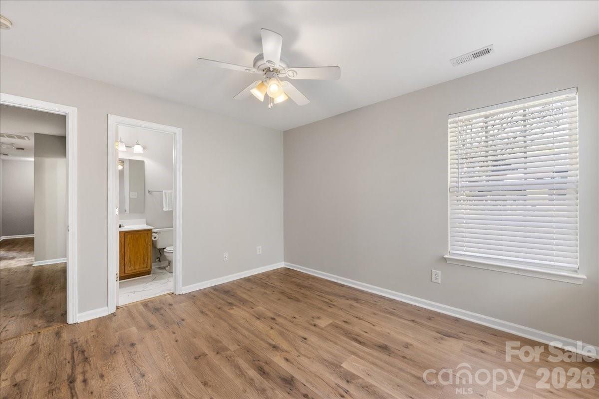 2872 Signal Court Southwest Concord, NC 28025 - Photo 23 of 43 a view of an empty room with wooden floor and a window