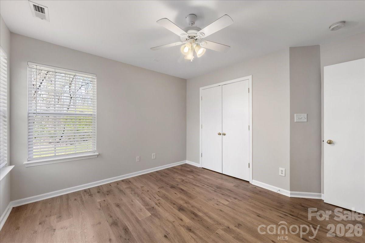 2872 Signal Court Southwest Concord, NC 28025 - Photo 24 of 43 a view of an empty room with wooden floor and a window