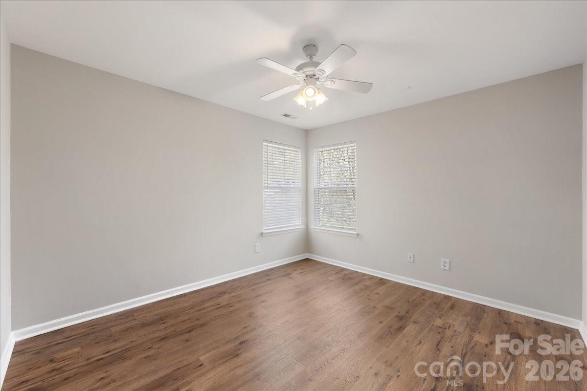 2872 Signal Court Southwest Concord, NC 28025 - Photo 25 of 43 a view of an empty room with wooden floor and a fan