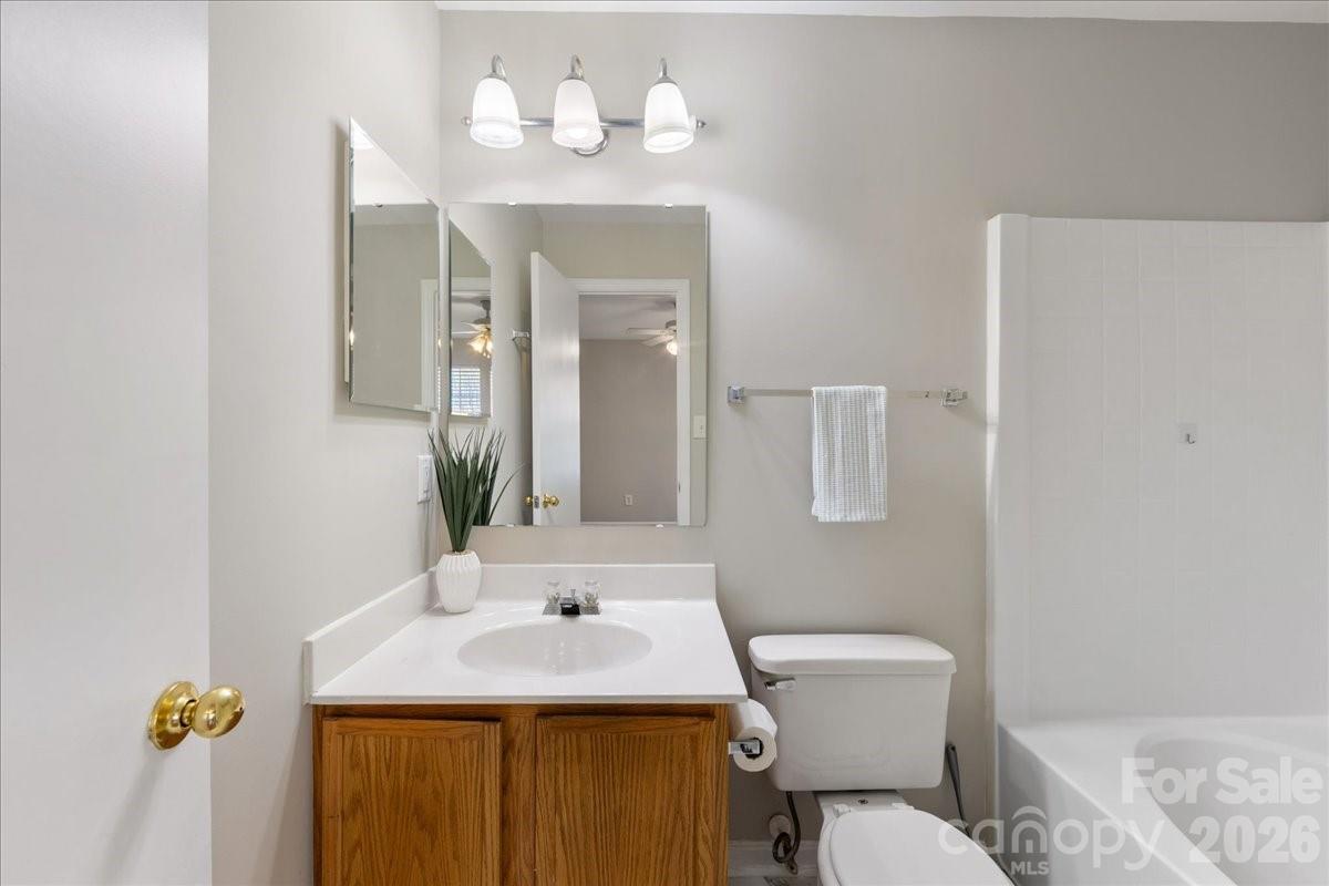 2872 Signal Court Southwest Concord, NC 28025 - Photo 26 of 43 a bathroom with a toilet sink and mirror