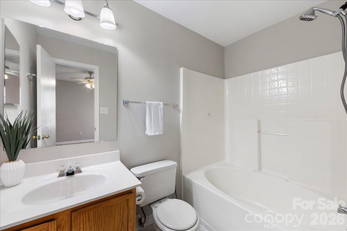 2872 Signal Court Southwest Concord, NC 28025 - Photo 27 of 43 a bathroom with a sink toilet and shower