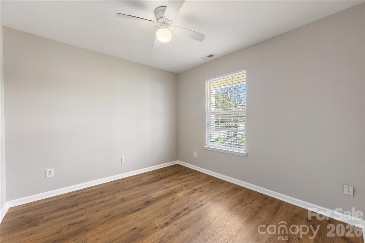 2872 Signal Court Southwest Concord, NC 28025 - Photo 28 of 43 wooden floor in an empty room with a window