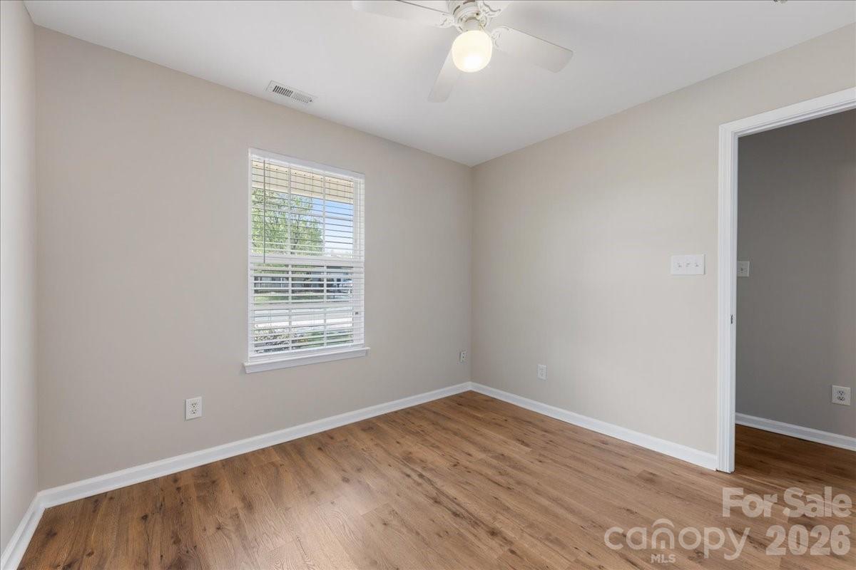 2872 Signal Court Southwest Concord, NC 28025 - Photo 29 of 43 a view of an empty room with wooden floor and a window