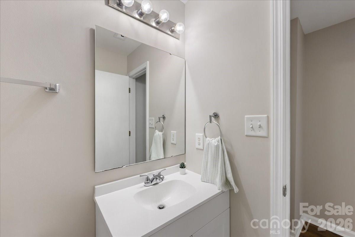 2872 Signal Court Southwest Concord, NC 28025 - Photo 33 of 43 a bathroom with a sink vanity and a mirror