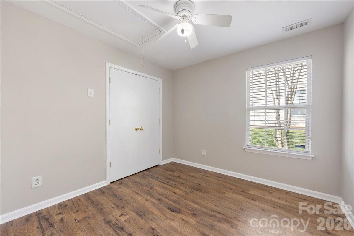 2872 Signal Court Southwest Concord, NC 28025 - Photo 34 of 43 a view of an empty room with wooden floor and a window