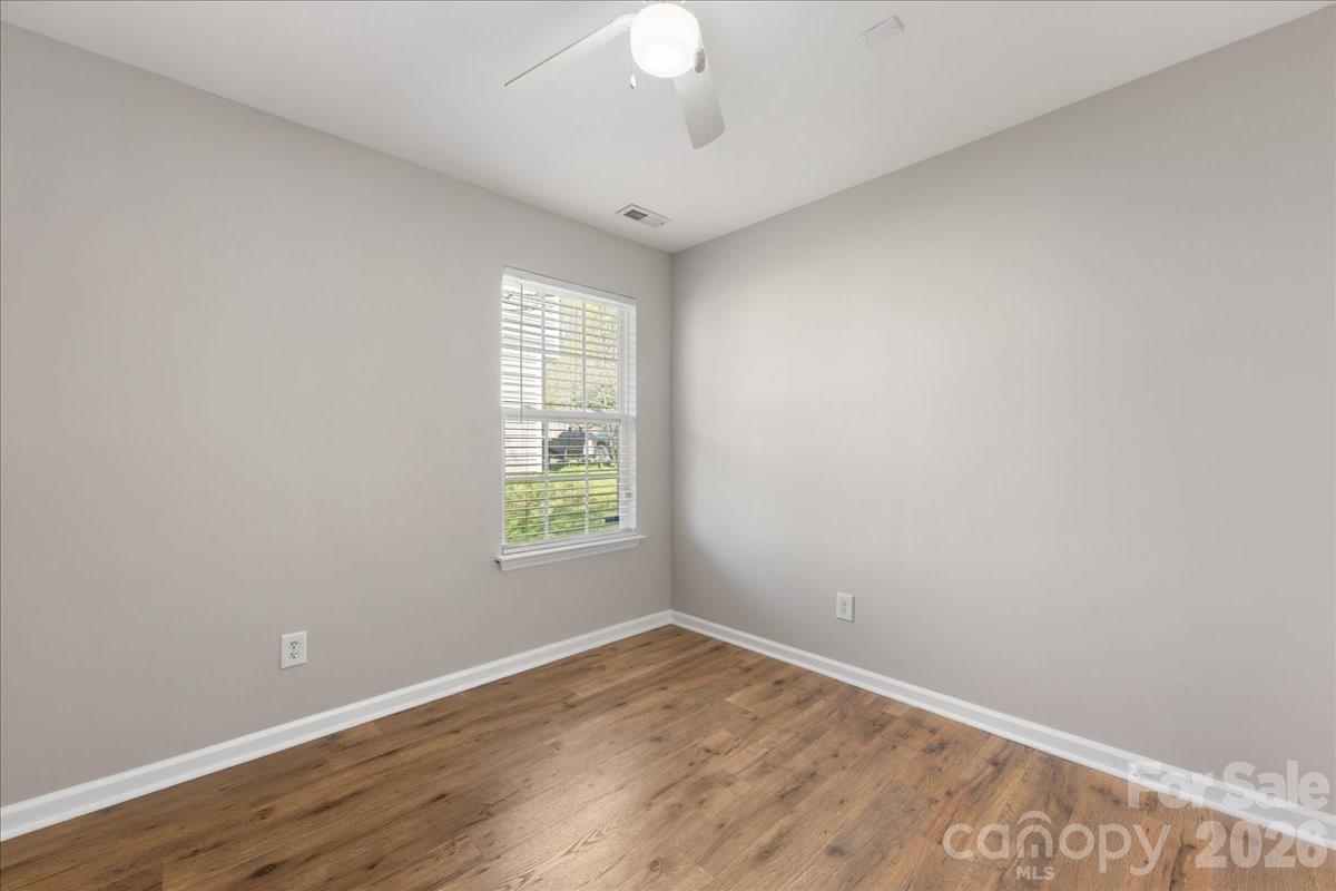 2872 Signal Court Southwest Concord, NC 28025 - Photo 35 of 43 an empty room with wooden floor and windows