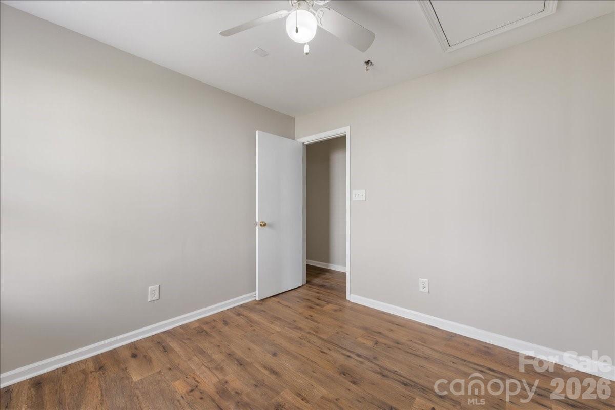 2872 Signal Court Southwest Concord, NC 28025 - Photo 36 of 43 an empty room with wooden floor and a ceiling fan