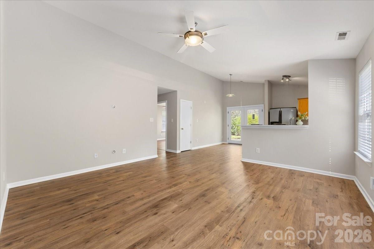 2872 Signal Court Southwest Concord, NC 28025 - Photo 9 of 43 a view of a kitchen with wooden floor and a ceiling fan