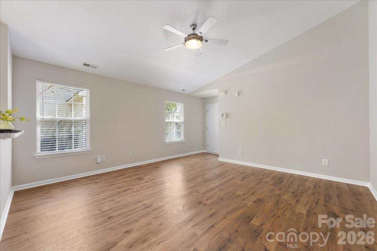 2872 Signal Court Southwest Concord, NC 28025 - Photo 10 of 43 an empty room with wooden floor and windows