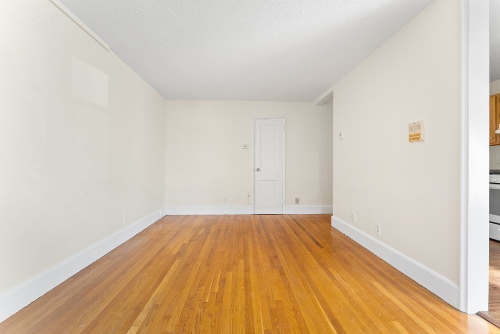 11 Victory Road, Unit 32 Boston, MA 02122 - Photo 10 of 16 a view of a room with wooden floor