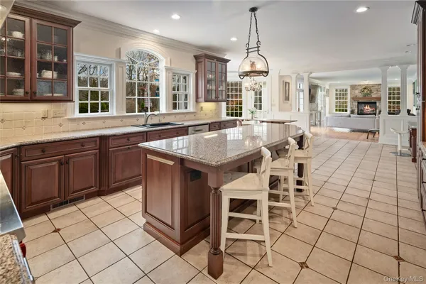 a large kitchen with granite countertop a stove a sink and a granite counter tops