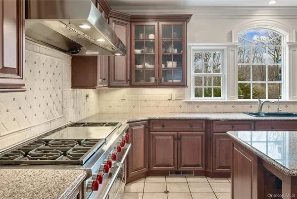 a kitchen that has a sink and a stove