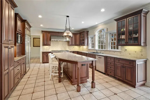 a kitchen with stainless steel appliances granite countertop a stove a sink and a refrigerator