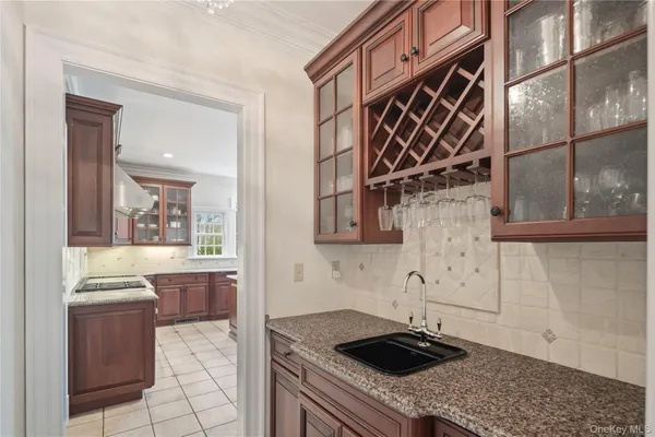a kitchen with a sink a stove and cabinets