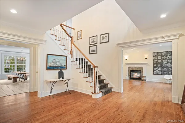a view of a livingroom with wooden floor and a fireplace