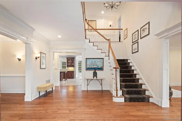 a view of entryway and hall with wooden floor