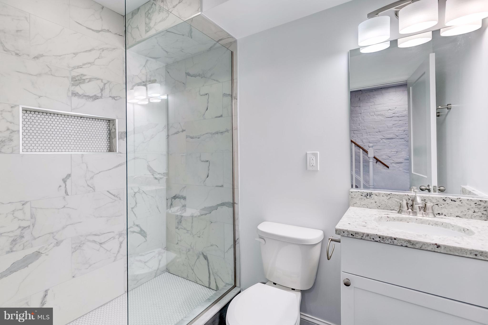 800 South Streeper Street Baltimore, MD 21224 - Photo 2 of 17 a bathroom with a granite countertop sink toilet and shower
