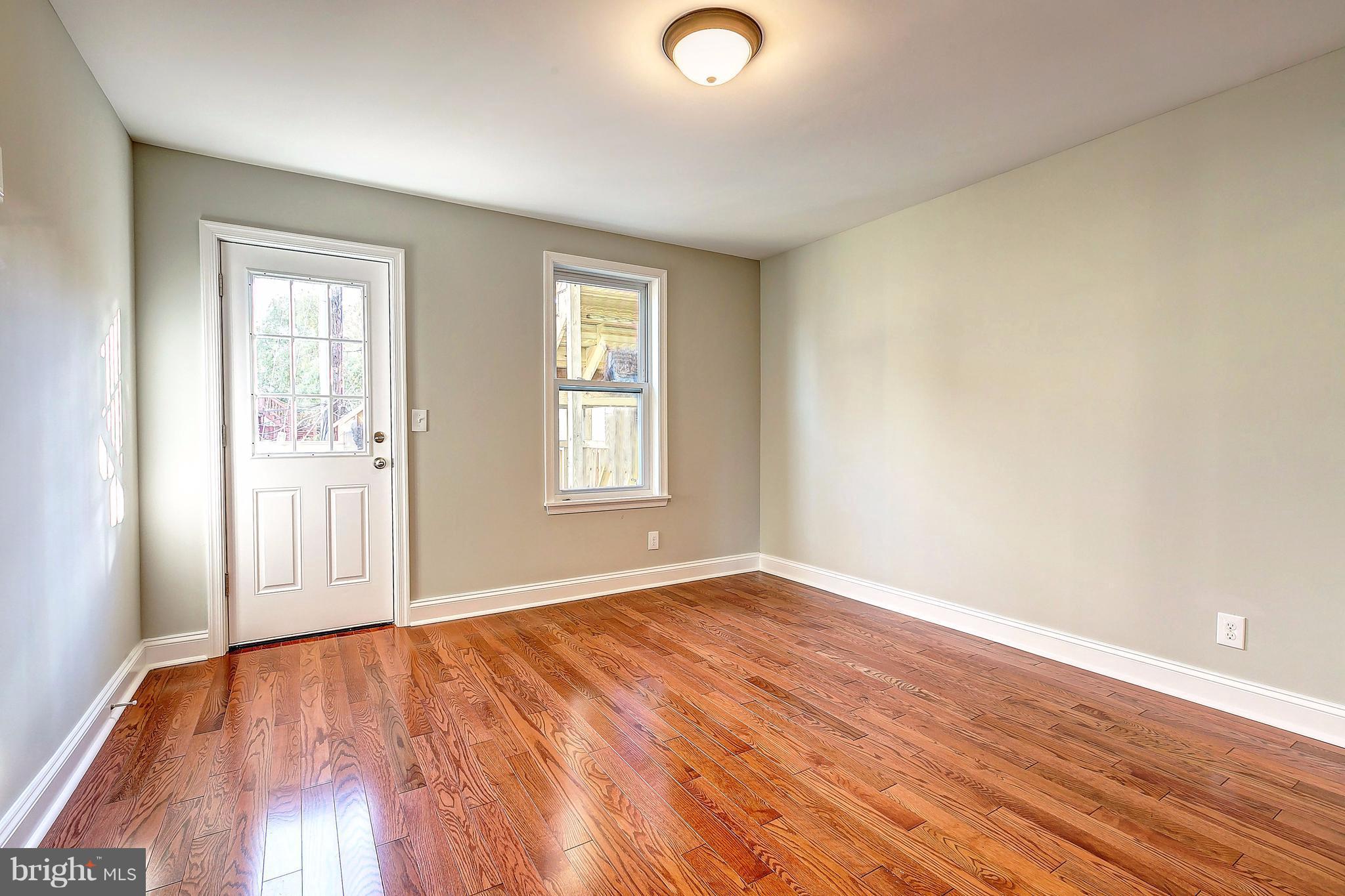 800 South Streeper Street Baltimore, MD 21224 - Photo 10 of 17 an empty room with wooden floor and windows