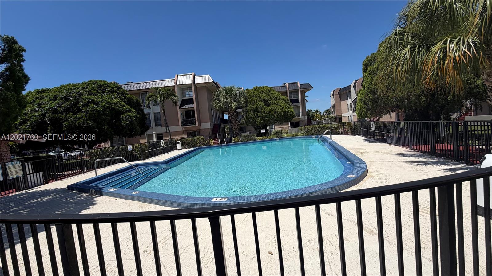 3901 Southwest 109th Avenue, Unit 4 Miami, FL 33165 - Photo 4 of 15 a view of a swimming pool with a patio