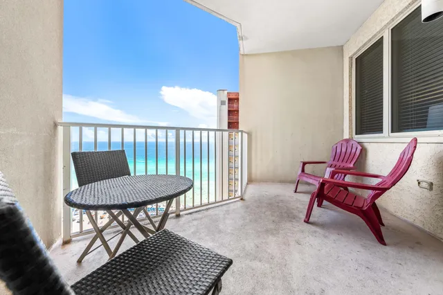 a balcony with chairs and a table