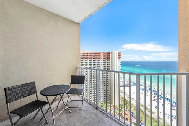 a balcony with table and chairs