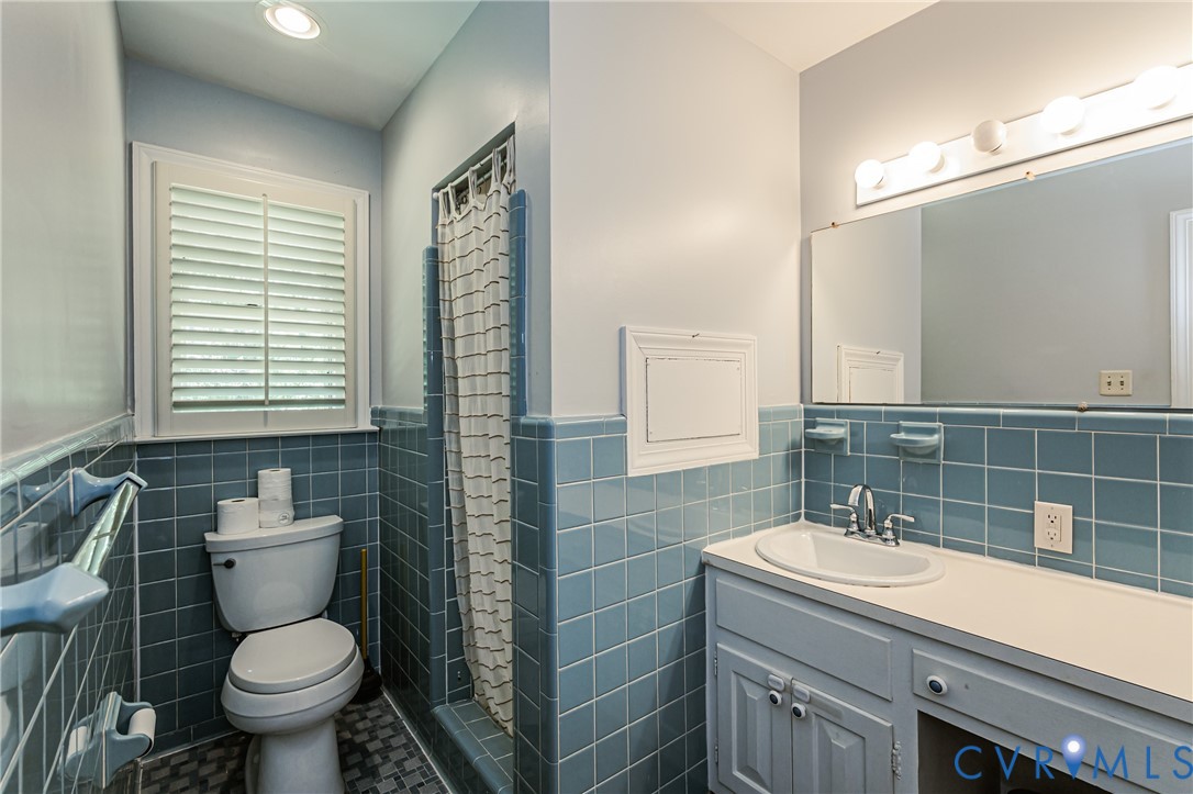 15611 Robert Terrell Road Montpelier, VA 23192 - Photo 19 of 28 Bathroom featuring blue square wall tiles, a vanit