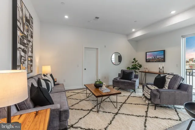 a living room with furniture and a rug