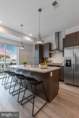 a kitchen with a table chairs refrigerator and cabinets