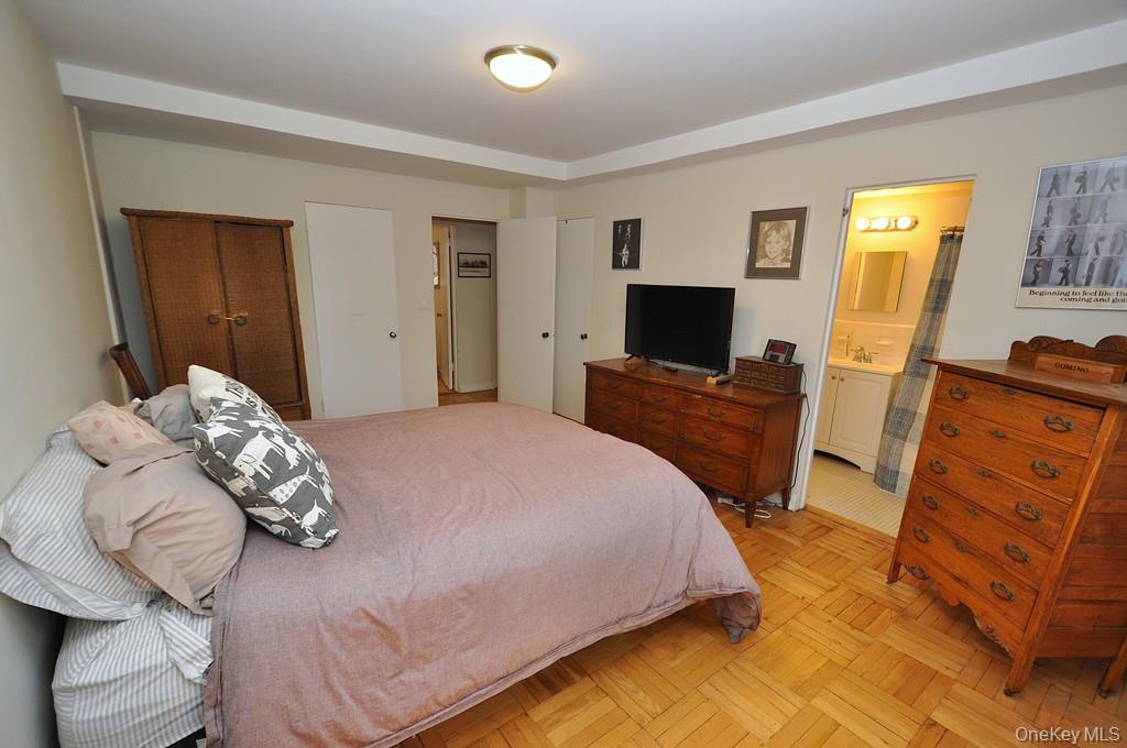 235 Garth Road, Unit A5B Scarsdale, NY 10583 - Photo 20 of 47 a bedroom with a bed and wooden floor