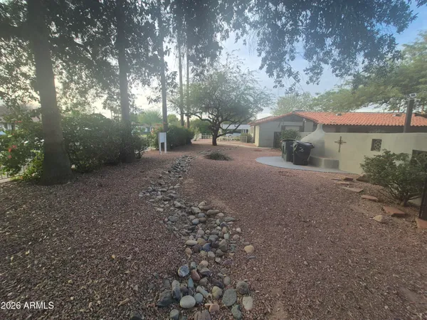 a view of a house with a tree and a yard