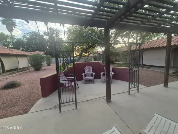 a view of a patio with table and chairs and potted plants