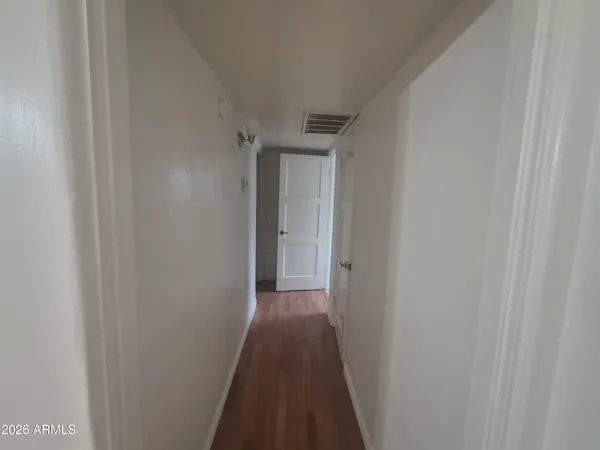 a view of a hallway with a wooden floor