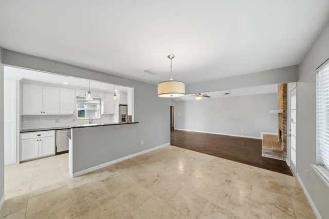 a kitchen with granite countertop white cabinets and white appliances