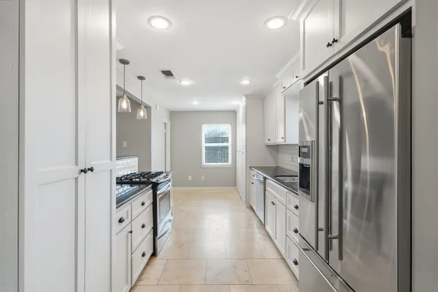 a kitchen with stainless steel appliances granite countertop a refrigerator and a sink