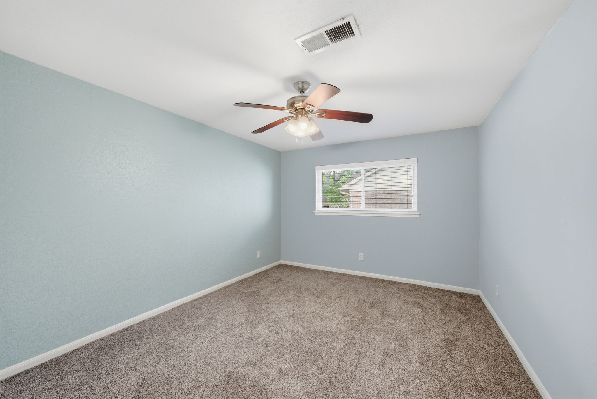 2502 Hollow Hook Road Houston, TX 77080 - Photo 24 of 35 an empty room with windows and fan