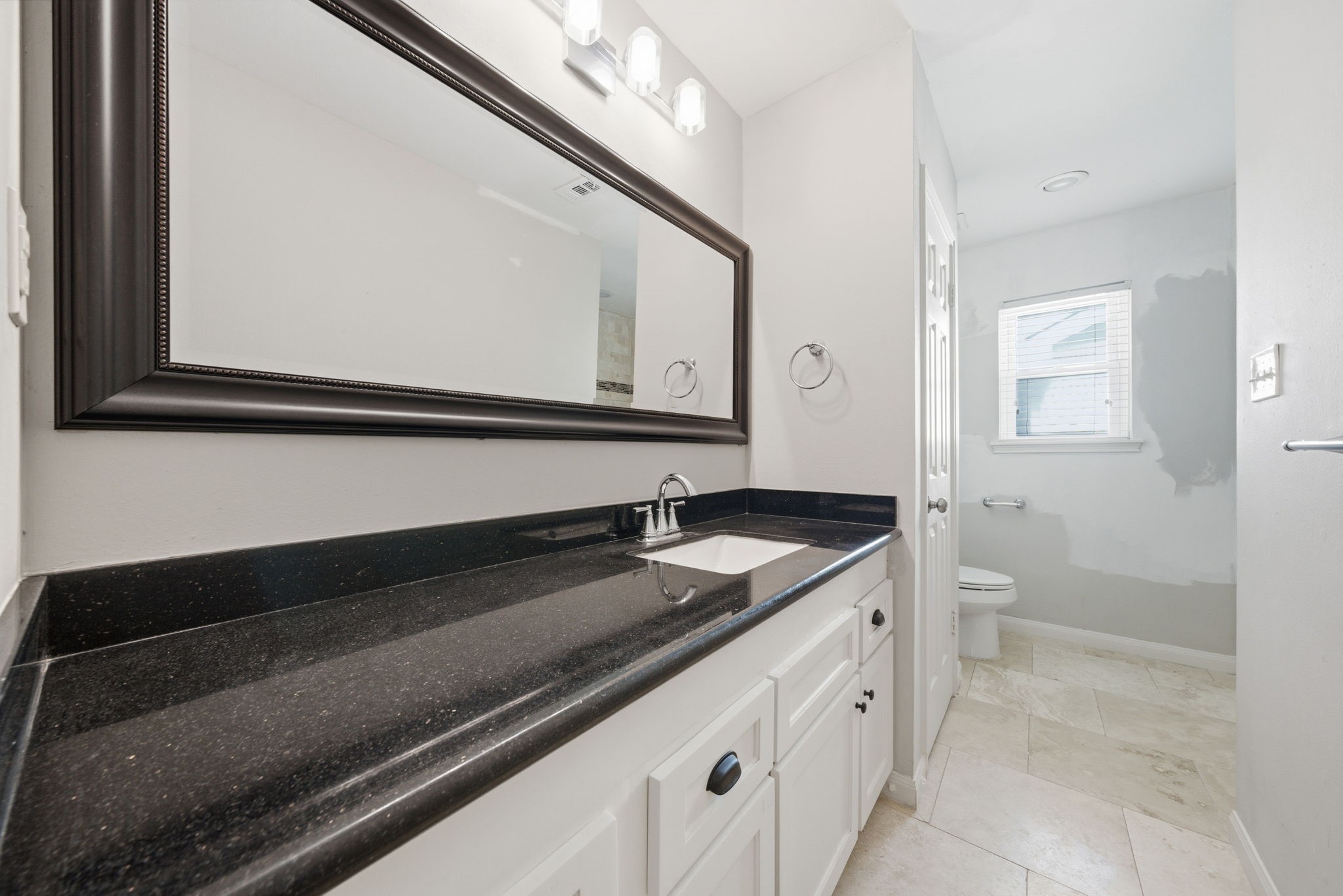 2502 Hollow Hook Road Houston, TX 77080 - Photo 27 of 35 a bathroom with a granite countertop sink and a mirror