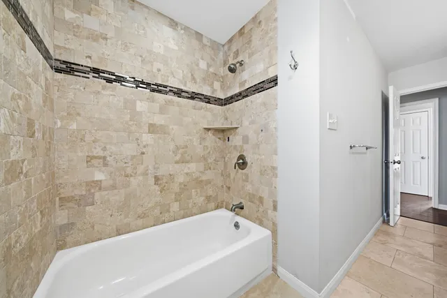 a bathroom with a bathtub and shower