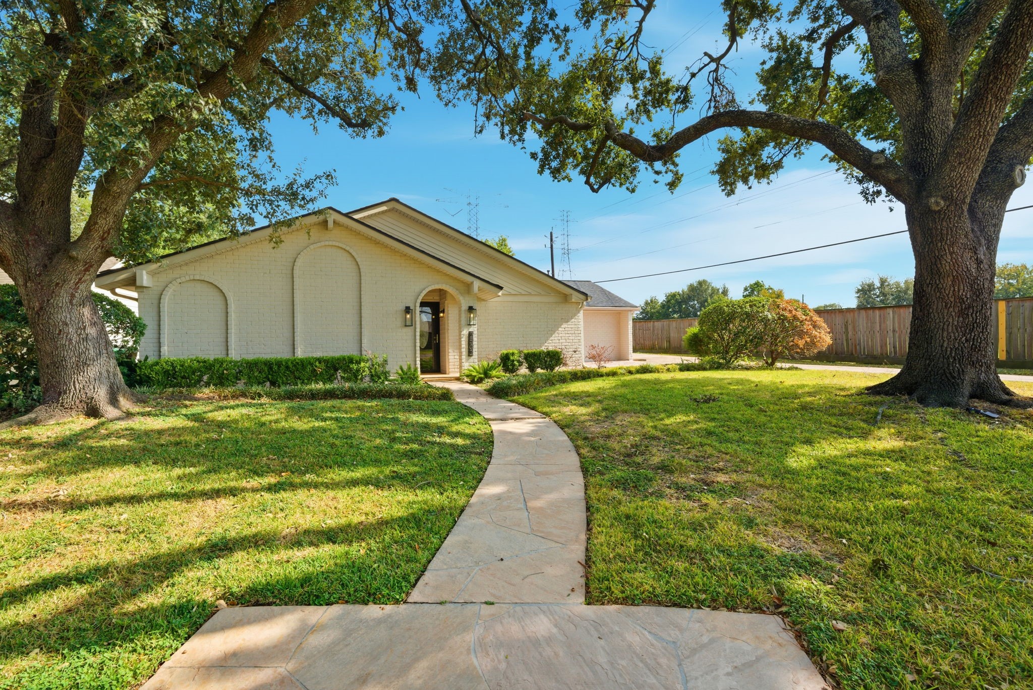 2502 Hollow Hook Road Houston, TX 77080 - Photo 3 of 35 a white house with a big yard plants and large trees
