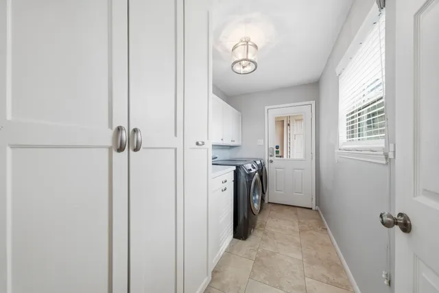 a view of backyard with wooden fence and large trees