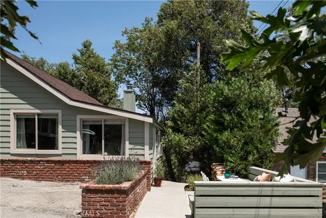 a patio with a table and chairs under an umbrella