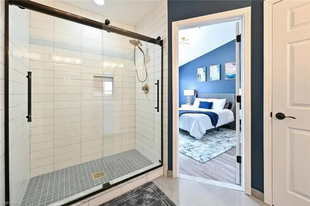 a bathroom with a granite countertop shower and a sink
