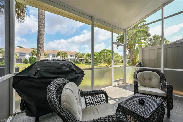 a balcony with table and chairs