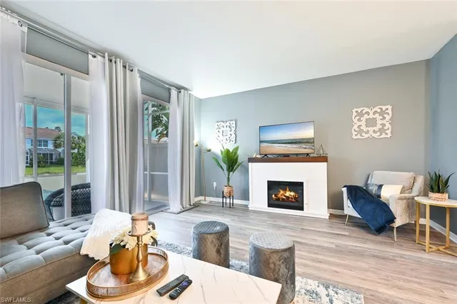 a living room with furniture mirror and a fireplace