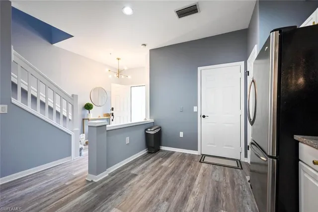 a kitchen with stainless steel appliances a refrigerator sink and cabinets