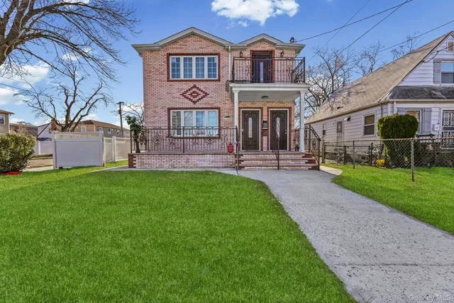 a front view of a house with a garden and plants