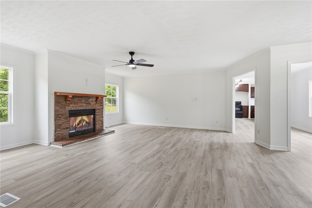 112 Sir Francis Drake Way Liberty, SC 29657 - Photo 17 of 42 This expansive living area offers a warm fireplace, abundant natural light, and durable flooring.