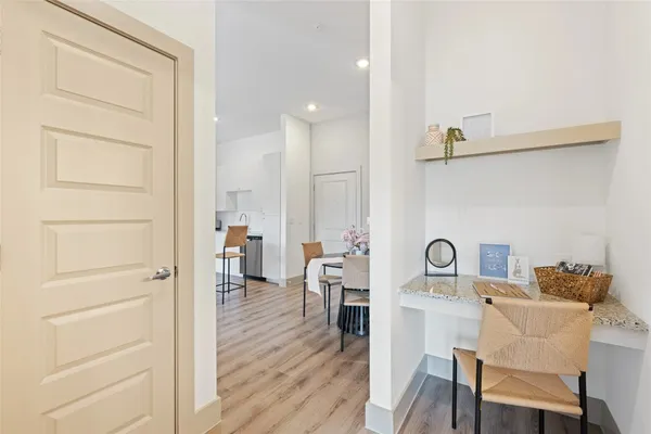 a dining room with furniture and wooden floor