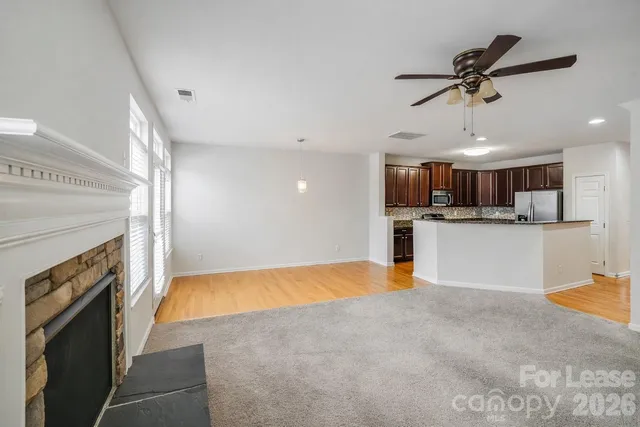 a kitchen with stainless steel appliances granite countertop a sink a stove and a refrigerator