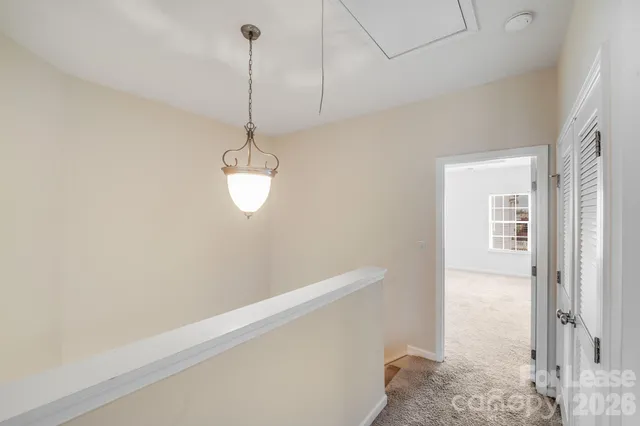a view of a room with wooden floor and windows